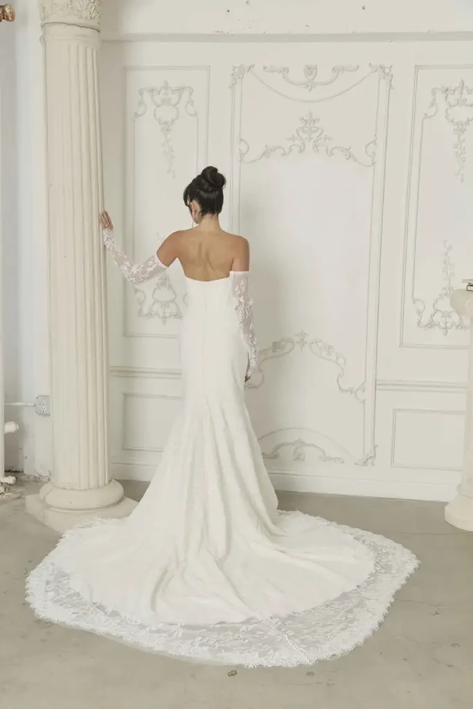 model is wearing a strapless fit and flare wedding dress