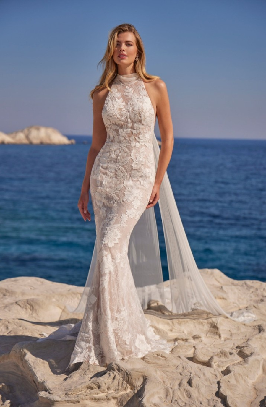 model is wearing a lace sleeveless sheath wedding gown