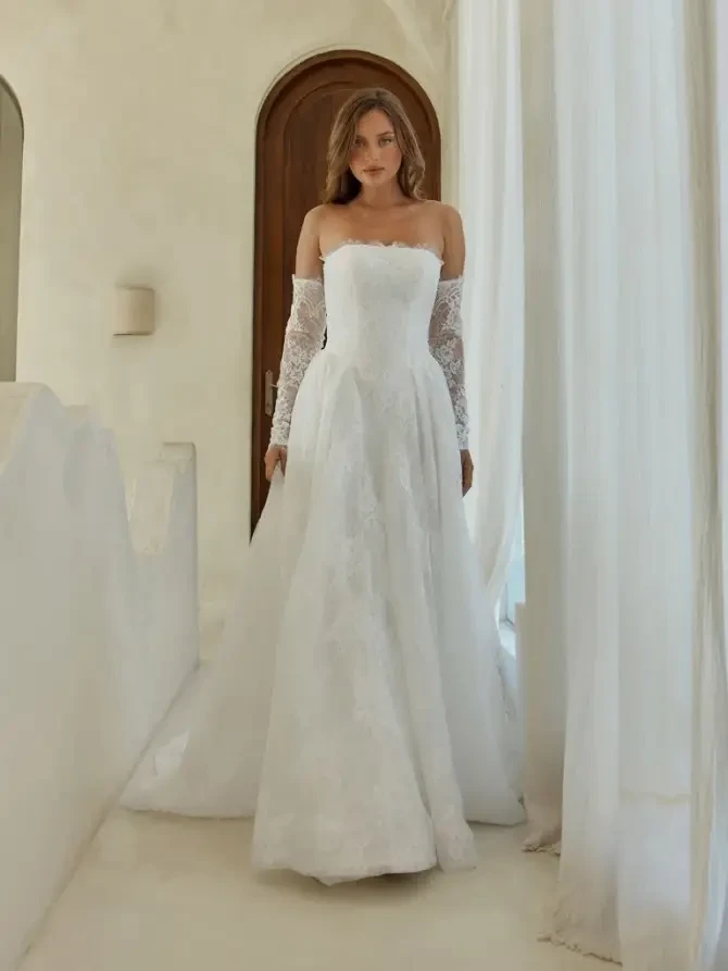 model is wearing a strapless a-line bridal gown