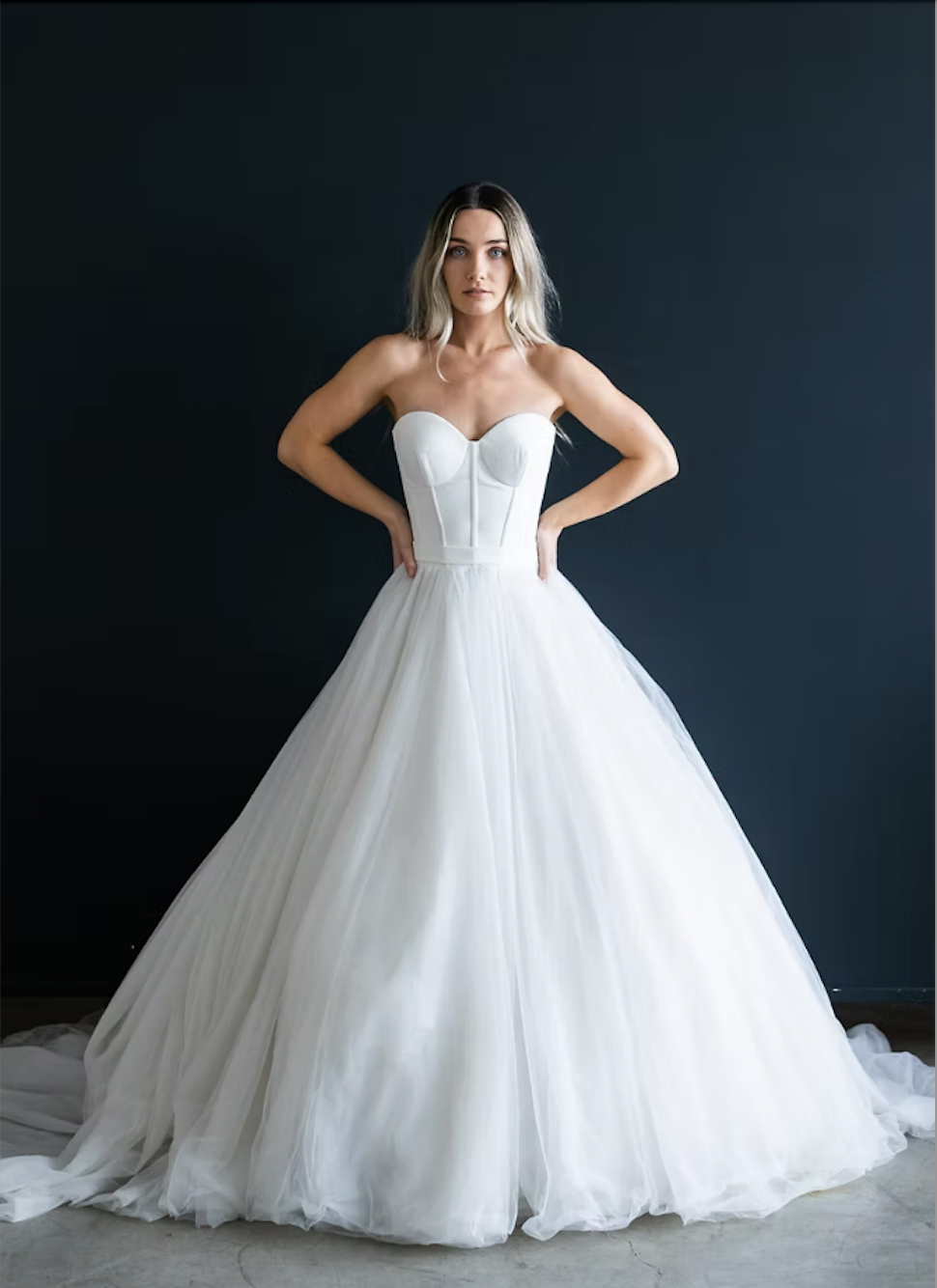 model is wearing a strapless ball gown bridal dress