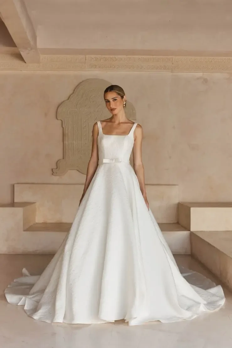 model is wearing a sleeveless a-line bridal gown