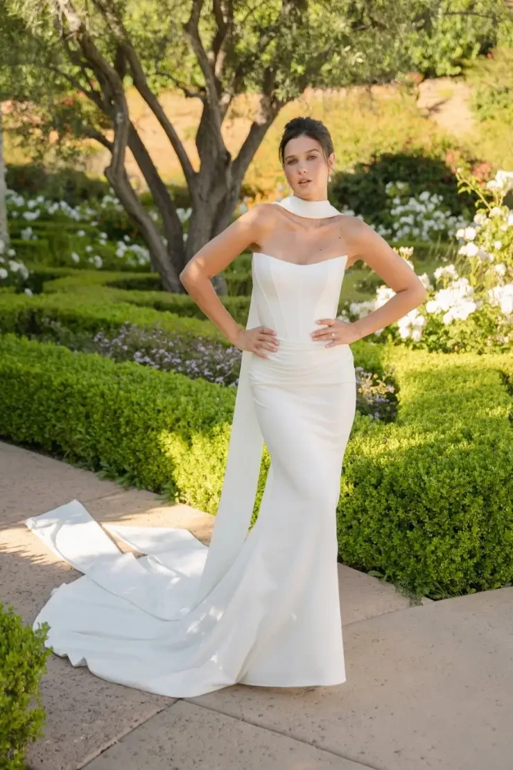 model is wearing a strapless fitted wedding gown