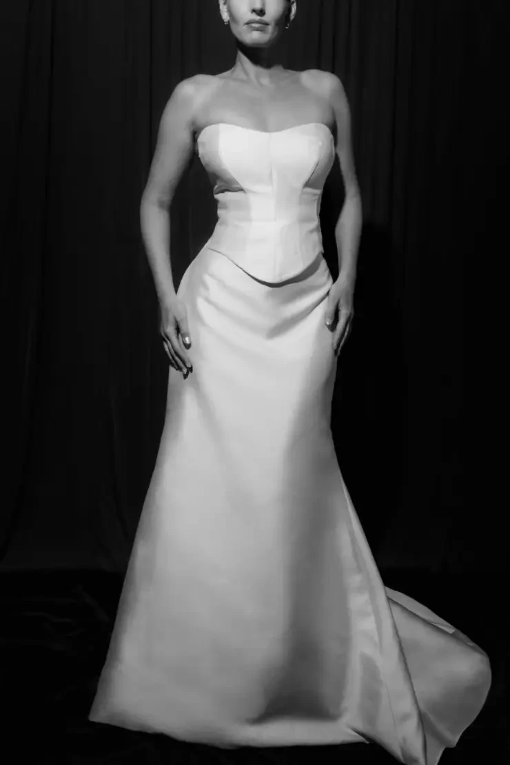model is wearing a strapless basque waist wedding gown