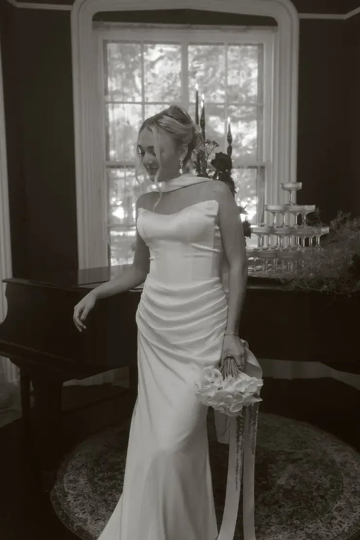 model is wearing a fitted strapless bridal gown